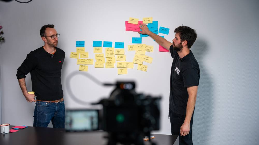A client workshop at the sticky-note wall, camera rolling