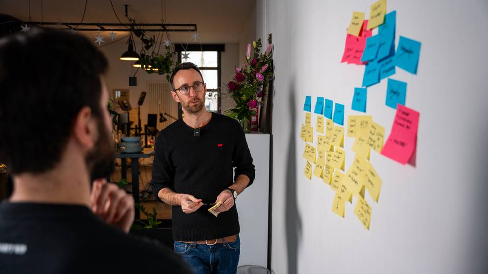 Ed running a client workshop at the sticky-note wall