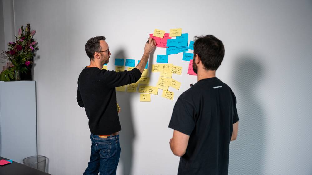 Working through a strategy wall of sticky notes in a client workshop